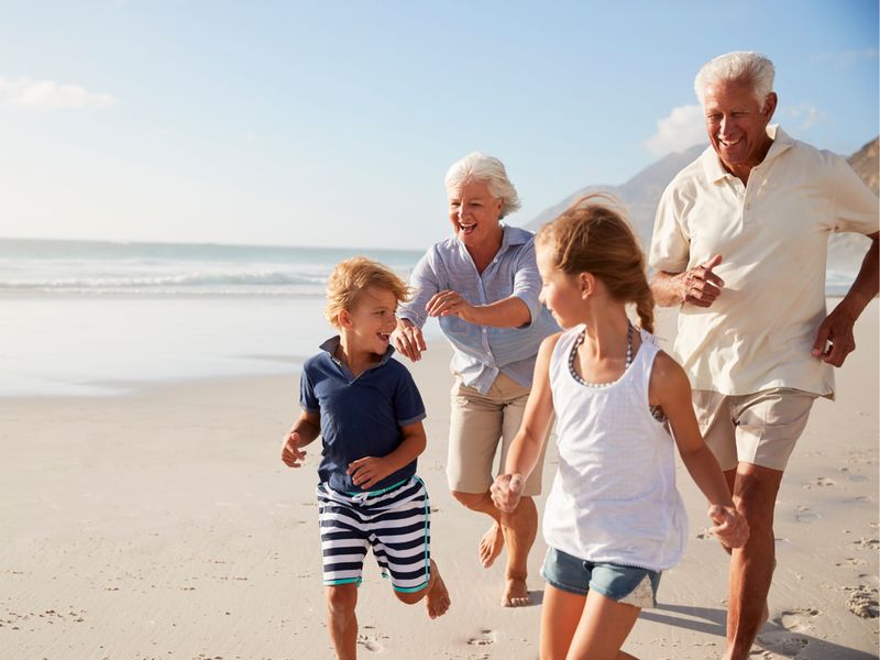 Grandparents and grandchildren on a beach, representing private client and estate planning advice at KMT Solicitors